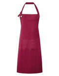 Premier's PR137 apron, featuring pockets and an adjustable neck strap, is showcased against a white background.