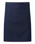 The Premier PR141 is a dark blue denim waist apron featuring a large front pocket. It boasts a simple, minimalistic design and is displayed against a plain white background.