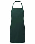 A Premier PR145 apron, featuring a dark green color with a neck strap and waist tie, displayed against a white background.