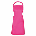 A bright pink apron from the Premier brand, model PR150, features a neck strap and waist ties and is displayed against a white background. It boasts a smooth and simple design with no visible pockets.