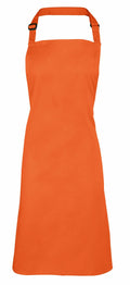 A bright orange Premier PR150 apron, featuring an adjustable neck strap, is displayed against a plain white background. This sleeveless apron extends to knee length and is ideal for cooking or crafts.
