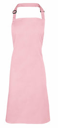 The Premier PR150 apron in plain pink features a neck strap and waist ties, showcased against a white background.
