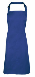 A Premier PR150 plain blue apron featuring a neck strap and waist ties, displayed against a white background.