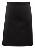 A sleek black skirt from Premier's PR151 collection, featuring a simple design and knee-length hemline, showcased against a white backdrop.