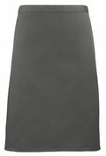 The PR151 by Premier is a plain, olive green skirt with a knee-length, straight cut design. It features a simple waistband and has neither visible embellishments nor patterns.