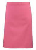On a plain white background, a vibrant pink, knee-length skirt from Premier's PR151 collection is showcased, featuring a simple and straight design.
