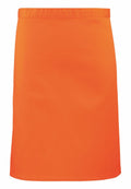The Premier PR151 is a bright orange skirt featuring a simple, straight design. The fabric is smooth and slightly shiny, making it suitable for casual or semi-formal occasions. It boasts a solid color without any additional patterns or embellishments.
