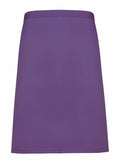 A Premier PR151 A-line skirt in a plain purple design, featuring a smooth fabric texture and displayed against a white background. The skirt is characterized by its minimalist waistline and clean, straight hemline.