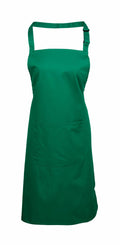 A Premier PR154 apron in green, featuring a neck strap and a spacious front pocket, is showcased against a simple white background.
