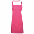The Premier PR154 apron is a vibrant pink, featuring an adjustable neck strap and a spacious front pocket, showcased against a white background.