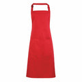 A vibrant red, full-length PR154 apron by Premier features an adjustable neck strap and a spacious front pocket. The fabric looks smooth and durable, ideal for cooking or crafting activities. It is showcased against a white background.