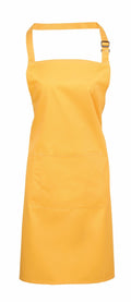 The PR154 apron by Premier is a vivid yellow with an adjustable neck strap and a spacious front pocket. It is showcased on a white background, highlighting its straightforward and practical design.