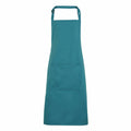 A Premier PR154 teal apron, featuring an adjustable neck strap and a spacious front pocket, showcased on a white background.
