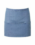 The Premier PR155 is a blue denim mini skirt featuring a straightforward, sleek design with a horizontal seam near the hem. The fabric offers a subtle texture and slight fade, adding to its casual yet timeless appeal, set against a plain white background.
