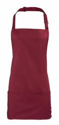 A Premier PR159 plain maroon apron featuring an adjustable neck strap and front pocket, showcased against a white background.