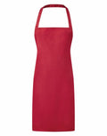 The Premier PR165 apron features a plain red design with a neck strap and waist ties, showcased against a white background.