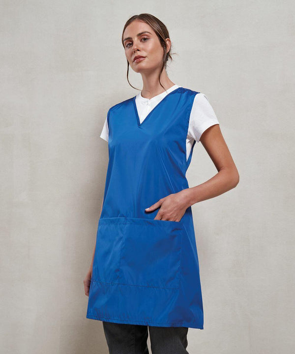 The Premier PR174 is being worn by a person, who is dressed in a blue smock over a white shirt, posing with one hand in the smock's pocket against a plain background.
