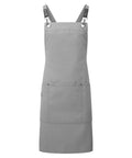 Aprons: A plain grey apron featuring adjustable black straps and a spacious front pocket, shown on a white background.