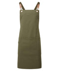 Aprons: Olive green apron with adjustable brown straps, chest pocket, large lower pocket, metal rivets, and two waist loops. Designed for utility or kitchen use.