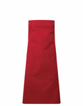 The Premier apron, model PR190, is showcased against a white background. This red apron features two pockets, along with neck and waist ties.