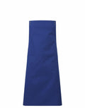 A Premier PR190 apron in plain blue, featuring two metal snaps at the top and a large front pocket, displayed against a white background.