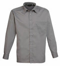 A neatly pressed Premier PR200, which is a gray long-sleeved button-up shirt featuring a collar and a chest pocket, is displayed against a plain white background.