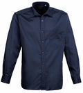 The Premier PR200 is a navy blue long-sleeve dress shirt featuring a front pocket and button-up closure.