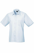 Premier's PR202 is a white short-sleeve button-up shirt, featuring a collar and a chest pocket.