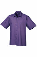 A Premier PR202, featuring a short-sleeved design in purple with a collar and a breast pocket, showcased against a white background.