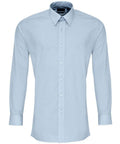 The Premier brand's PR204 shirt is a light blue, long-sleeve button-up featuring a pointed collar and displayed in a front-facing view.