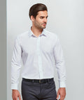 A man wearing a white Premier PR204 dress shirt and dark trousers, standing with his hands by his sides, looking to the left.