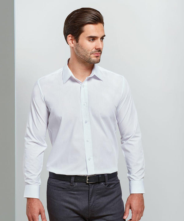 A man wearing a white Premier PR204 dress shirt and dark trousers, standing with his hands by his sides, looking to the left.