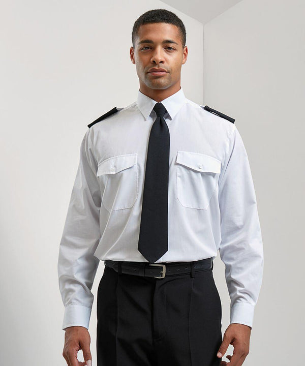 A man in a Premier PR210 pilot uniform with a white shirt, black tie, and black pants is standing against a plain white background.