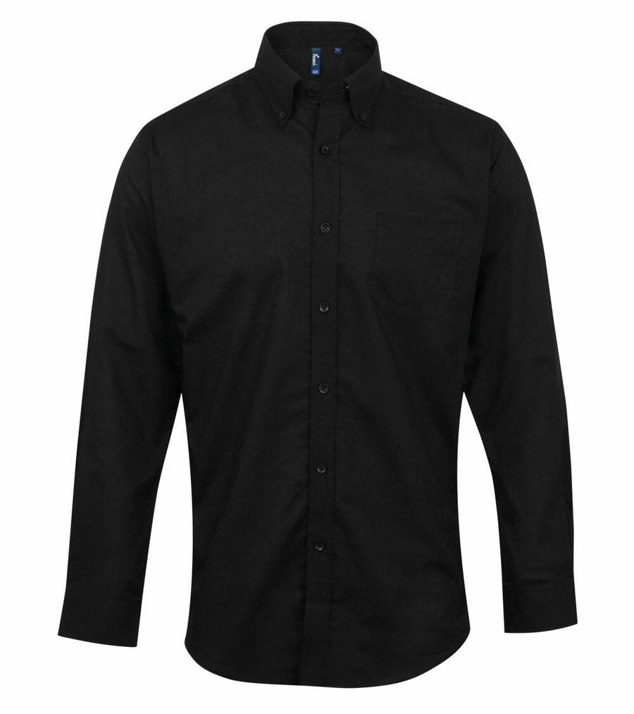 Premier's PR234 is a black button-up shirt featuring a collar and long sleeves, displayed against a white background.