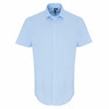 A PR246 short-sleeve button-up shirt in sky blue from the Premier brand, featuring a collar and displayed against a white background.