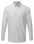 The Premier PR252 shirt is a long-sleeved, button-up piece with a light gray and white checkered pattern. It showcases a classic collar and boasts a smooth, minimalist design.