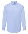 A long-sleeve, light blue button-down collared shirt from Shirts, featuring white buttons, displayed on a plain white background.