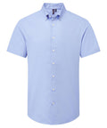 A light blue, short-sleeve button-up shirt from Shirts is shown against a white background. It features a button-down collar, white buttons, and has no visible pockets or patterns.