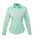 Light green PR300 long-sleeve button-up shirt with a collar by Premier, displayed against a plain white background.