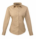 The PR300 by Premier, a beige long-sleeve button-up shirt, is displayed against a white background. It features a pointed collar and fitted cuffs.