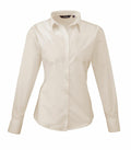 Displayed on a white background is the PR300, a cream-colored, long-sleeve button-up shirt by Premier. It features a classic collar, buttoned cuffs, and a fitted design.
