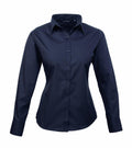 The PR300, a navy blue long-sleeve button-up shirt by Premier, is displayed on a white background. It features a classic collar and is tailored for a fitted look.