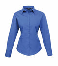 The Premier PR300 is a long-sleeve button-up shirt in blue, featuring a pointed collar. It has a tailored fit and buttoned cuffs, showcased against a white background.