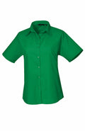 A short-sleeve, green PR302 button-up shirt with a collar from Premier, displayed against a plain white background.
