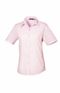 A light pink short-sleeve PR302 button-up shirt with a collar from Premier, shown against a white background.