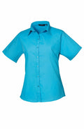The image features a Premier PR302 short-sleeve button-up shirt in a bright blue color with a collar, set against a white background.