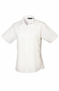 The Premier PR302 is a plain white, short-sleeved button-up shirt featuring a collar, displayed against a white background.