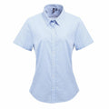 The Premier PR321 is a light blue short-sleeve button-up shirt with a collar, displayed against a white background.