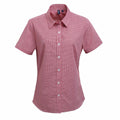 The PR321 shirt by Premier, a short-sleeved red checkered button-up with a collar, is displayed on a plain white background. It features white buttons down the front and offers a fitted, tailored design.