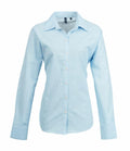 Premier's PR334 is a light blue button-up dress shirt featuring long sleeves and a collar.
